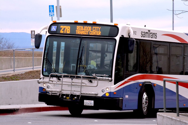 SamTrans bus 278 driving on a campus roadway.