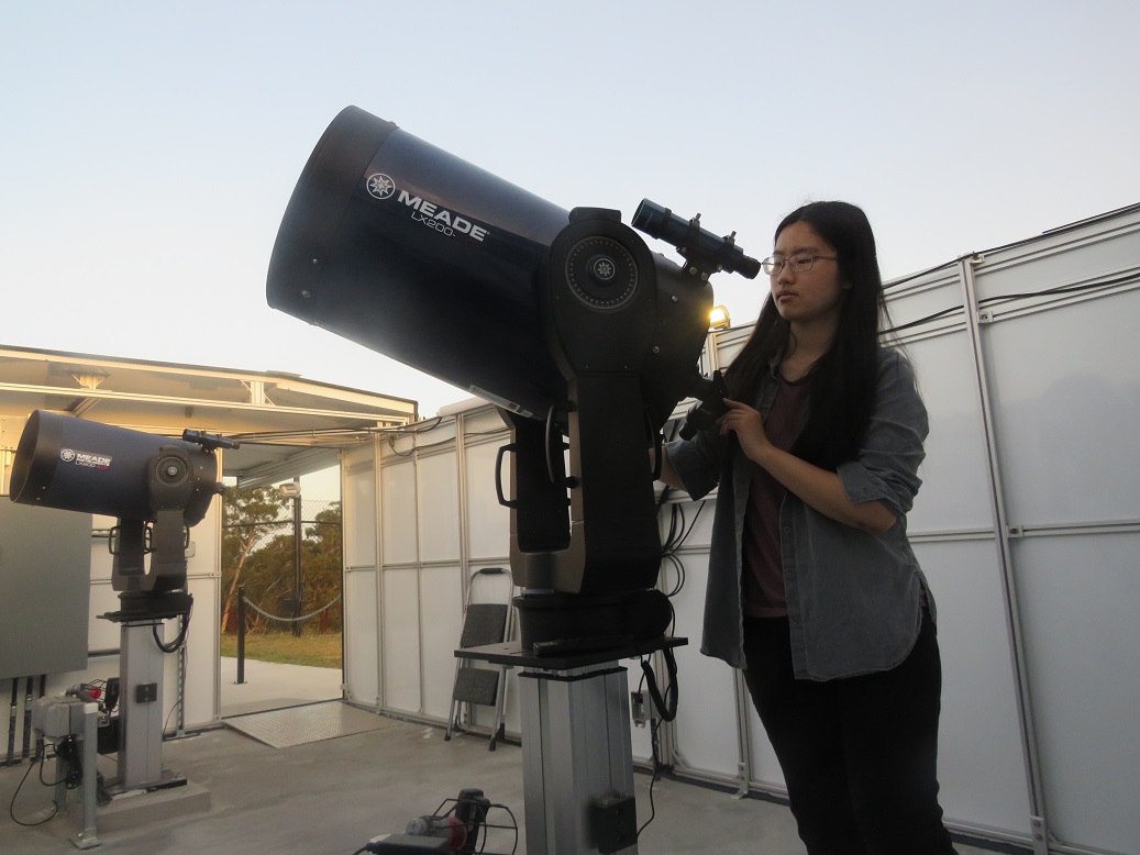 Canada student adjusting a telescope at our observatory.