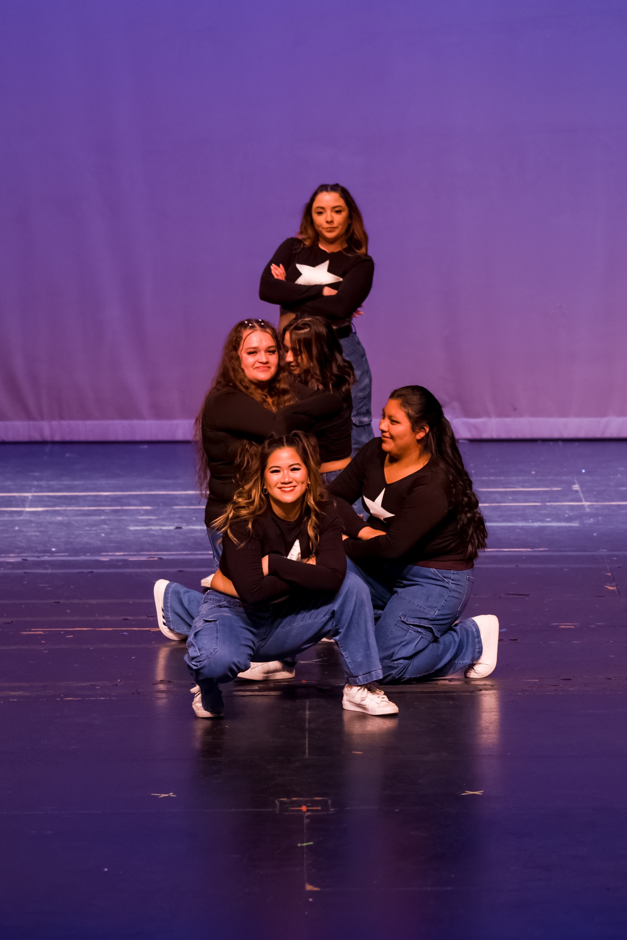 four dancers posing