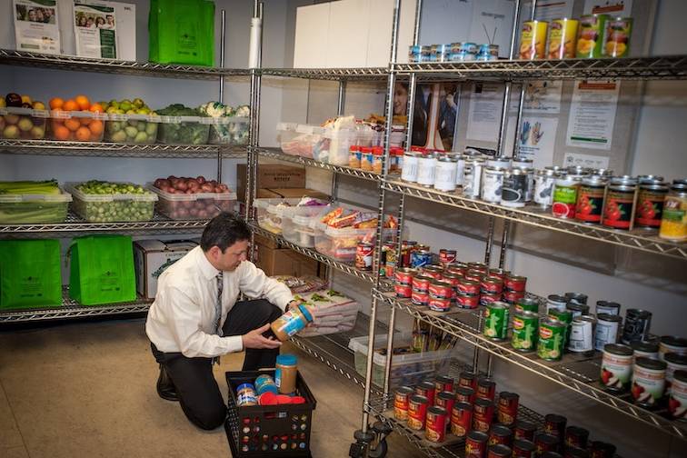 A staff member replenishes shelves in the food market.