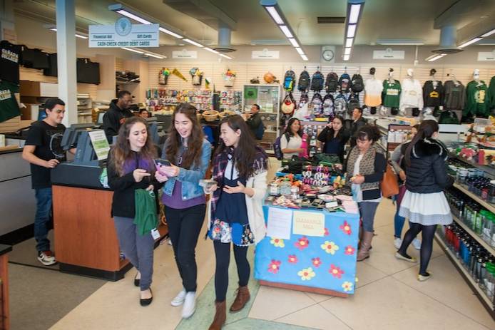 Students browsing and shopping for apparel and supplies in the bookstore.