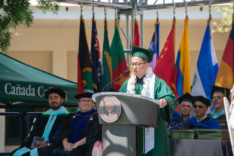 2023 Commencement Speaker Louis Tang on stage giving his speech 