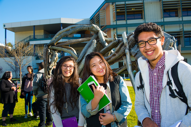 Students by horse sculpture on upper lawn