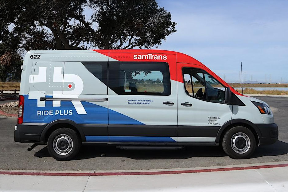 Ride plus van with SamTrans branding and colors parked next to a sidewalk